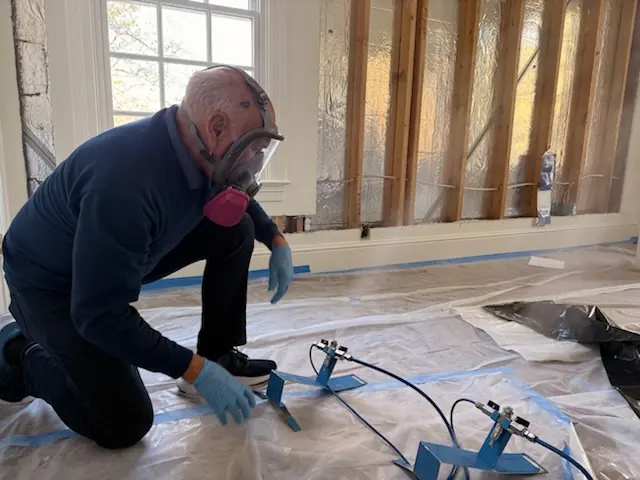 A restoration technician setting drying equipment in a Arlington home stripped to the studs